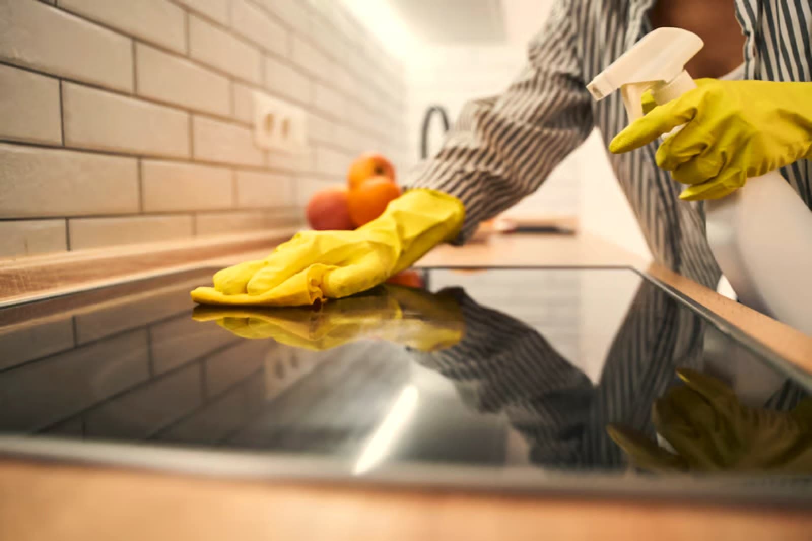 Mila’s House Cleaning team member cleaning a kitchen